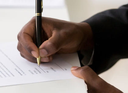 Close up of man signing contract